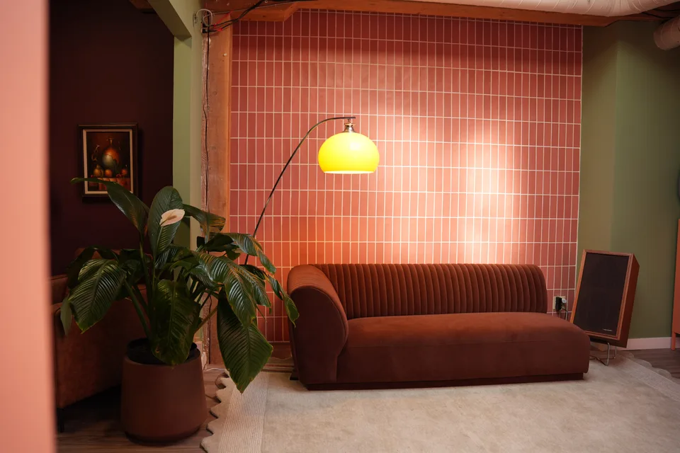 The Tulum Lounge seating area with its tiled wall and arc lamp